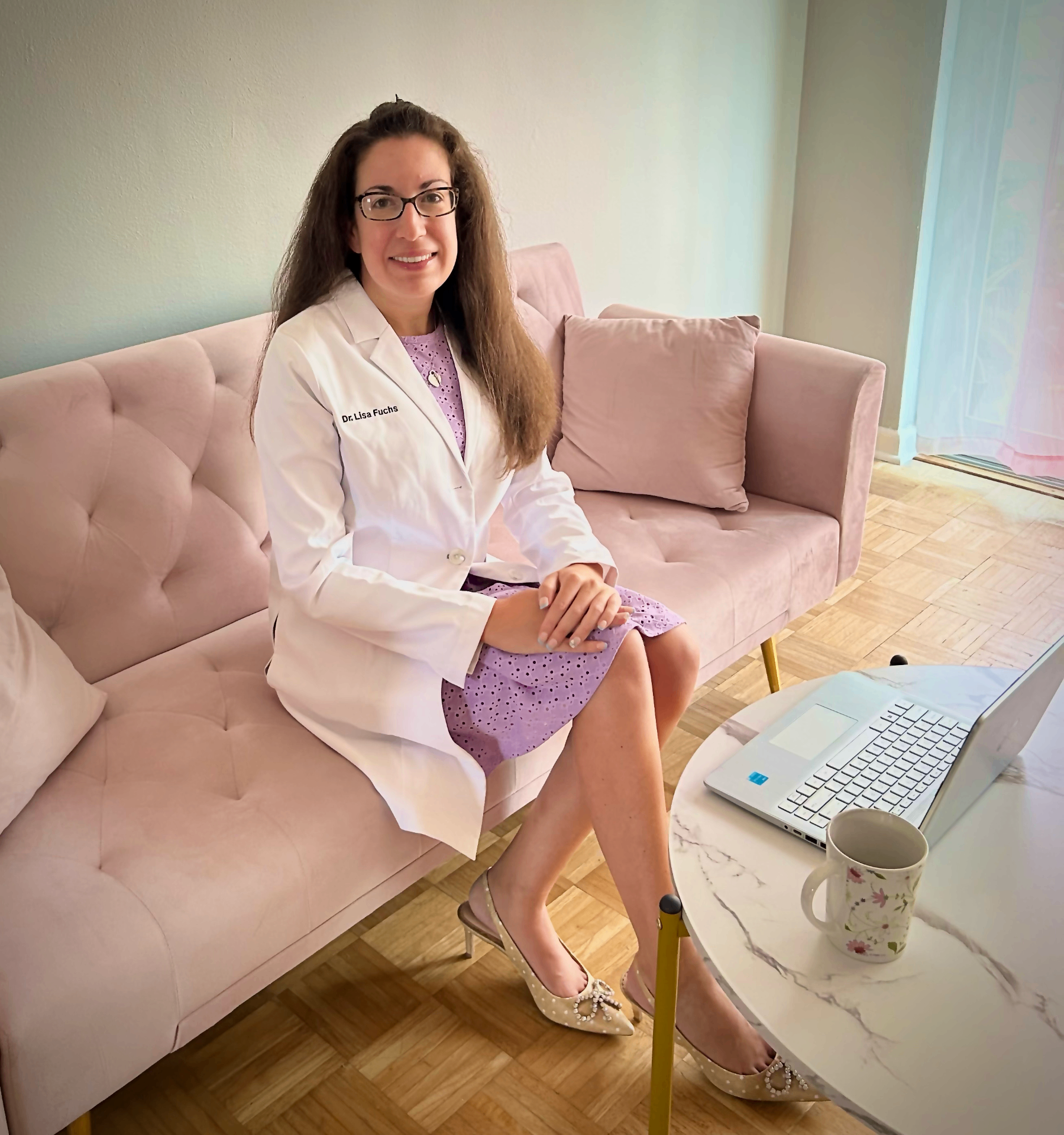 Dr. Lisa Fuchs in her white coat outside the practice.